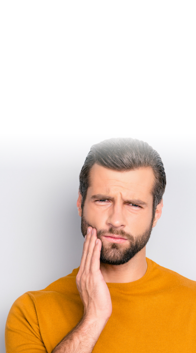Close up portrait of nervous unhappy troubled handsome bearded man touching his cheek he has toothache isolated on gray background copy-space